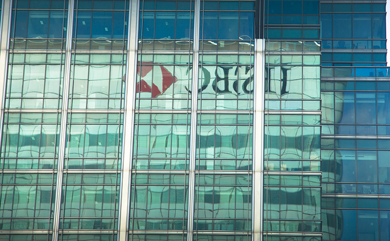 The HSBC headquarters in London is reflected in the glass of a nearby building